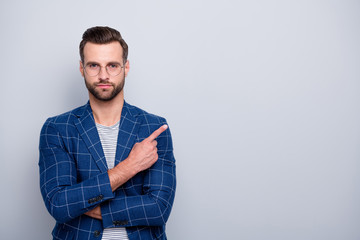 Canvas Print - Photo of confident handsome attractive man pointing into empty space wearing spectacles checkered blazer isolated grey color background