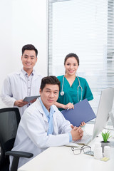 Wall Mural - happy doctors at hospital office. Healthcare concept