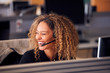 © Monkey Business - Laughing Businesswoman Wearing Telephone Headset Talking To Caller In Customer Services Department