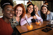 © Zoran Zeremski - Group of young female friends having fun in cafe, talking and laughing while sitting at table and making selfie.