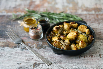 Wall Mural - Baked Brussels sprouts with rosemary and spices. Frying pan with baked brussels sprouts.