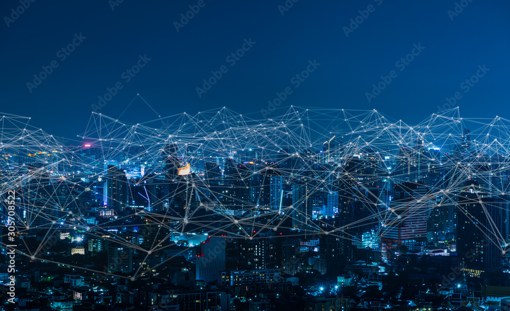 Modern city with wireless network connection and city scape concept.Wireless network and Connection technology concept with city background at night. - obrazy, fototapety, plakaty 