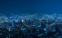 Modern City With Wireless Network Connection And City Scape Concept.Wireless Network And Connection Technology Concept With City Background At Night.