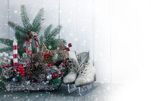 Christmas Background With Wicker Basket, Skates For Figure Ice Skating, Fir Tree On Wooden Old Shabby Table, New Year Holiday Rustic Home Interior Decor.