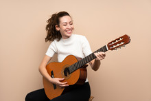 Young Woman With Guitar Over Isolated Background