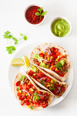 Wall Mural - mexican beef and pork tacos with salsa, guacamole and vegetables