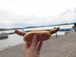 Hot dog in hand with bread that I saw the sky
