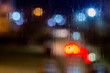 © lucky pics - an abstract background night street lights bokeh through wet glass, close-up with selective focus