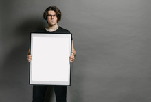 Man Holding A Picture Frame Or Poster For Mock Up Wearing Black Clothes