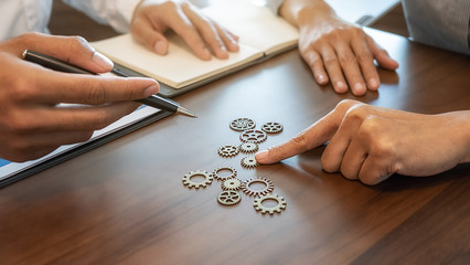 Wall Mural - Business Solutions for Success and Strategy. Business team brainstorming and connecting the gears with a puzzle. Fulfill and fix the problem of incomplete teamwork.