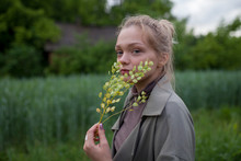 Young Woman Holding Green Branches