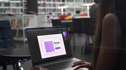 Young Woman Graphic Designer Works on Laptop, Looking at the Screen. Professional Creative Millennial Sitting at Desk in Office Studio Working 4K. Working in the Designer Program Close Up.