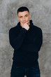 © dimadasha - Photo session of a guy in a sweater on the eve of the new year.