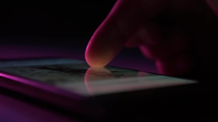 man`s finger touching and scrolling a phone screen with instagram information