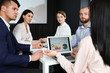 © New Africa - Business people having meeting in conference room with video projection screen