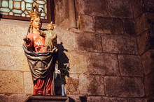 Santiago De Compostela, Spain - 10/13/2018: Medieval Statue Of Our Lady With Jesus Christ Baby. Saint Mary With Jesus Baby Filtered. Ancient Religious Architecture. God Mother With Son Stone Monument.