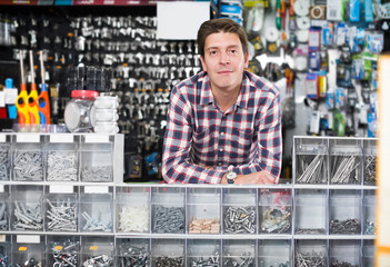 Wall Mural - Portrait of smiling seller working with manufacturing keys