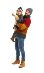 Wall Mural - Happy father and son in warm clothes on white background. Winter vacation