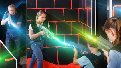 cheerful young parents and children with laser pistols playing l