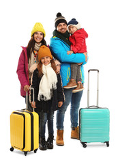 Canvas Print - Happy family in warm clothes with suitcases on white background. Winter vacation