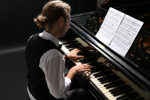 Man Playing Grand Piano At The Concert