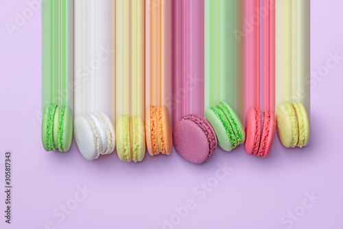 Fotomural Top view of colorful macaron biscuits in a row on pastel color block background,