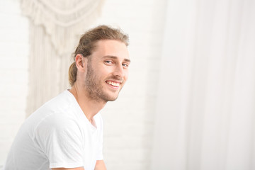 Wall Mural - Young man with hearing aid at home