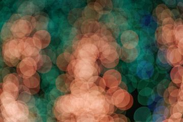Wall Mural - Orange, red and green Christmas light shiny abstract round bokeh on dark background. Colourful Glitter bokeh from blurry decoration bulbs.