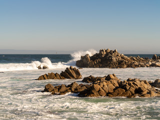 Poster - Waves crashing onto jagged rocks on the California coast near Monterey Bay.