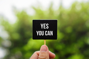 Wall Mural - Yes You Can. Hand Holding Stick Blackboard.