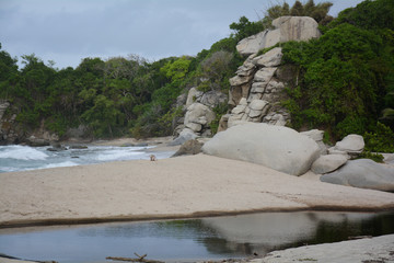 blue beaches and contrast of rocks and jungle in the national natural park tairona colombia