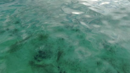 Wall Mural - flying above tropical water, opening shot discovering sunset sea scenery, camera moving forward and 