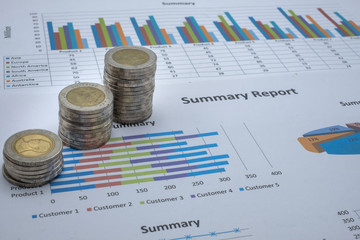 A pile of coins that are stacked on the graph. House and property concept Tax finance chart. Movable property, mortgages and real estate investments for savings or investments for homes.