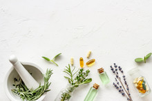 Apothecary Of Natural Wellness And Self-care. Herbs And Medicine On White Background Top View Frame Copy Space