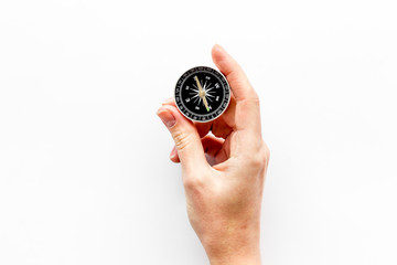 Wall Mural - Choose direction concept. Compass in hand on white background top view copy space