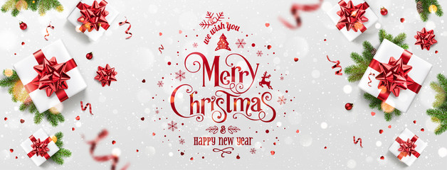 Wall Mural - red christmas and new year text on xmas background with gift boxes, fir branches, red ribbon, decora
