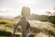 © Josh - Close up of young woman stretching in park