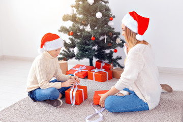 Wall Mural - Single parent and holidays concept - Portrait of mother and son celebrating christmas at home on christmas eve