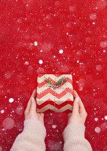 Woman Holding Christmas Presents On A Red Table Background...