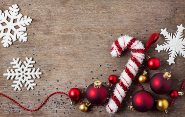 Christmas composition with Christmas balls, snowflakes and candy tree toy on wooden background. Christmas, new year concept. Flat lay, top view, copy space