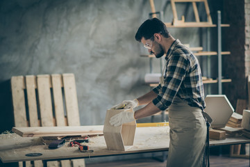 Wall Mural - Profile side photo of focused man worker work with wooden shelf restore renew furniture polish surface in home garage