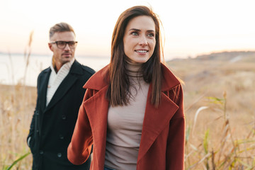 Beautiful smiling couple wearing autumn clothing