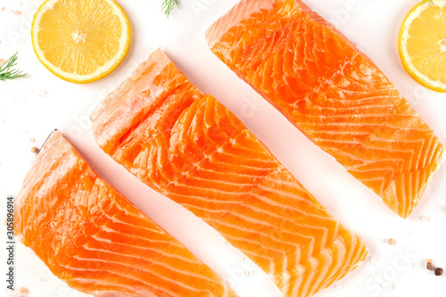 Fotografía Slices of salmon with lemon, a flat lay close-up top-down shot with salt and pep