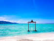 Gili Islands, Indonesia, Asia. Beautiful beach crystal clear water and white sand in an exotic tropical destination. Famous wooden water swing. Popular instagram location. 
