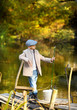 © azhurfoto - Kid fishing in a river, sitting on a wood pontoon