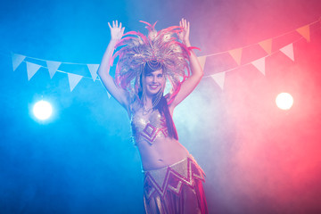 Carnival, dancer and holiday concept - Beauty brunette woman in cabaret suit and headdress with natural feathers and rhinestones.