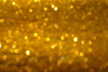 Blurry abstract golden background with bokeh lights