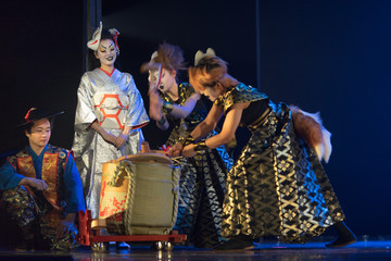 Wall Mural - Traditional Japanese performance. Actors in traditional costumes pouring sake from the barrel on the stage.