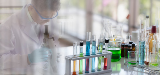 Wall Mural - laboratory concept: glassware in a chemical laboratory with a blurred background of the scientist in