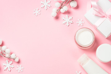 Wall Mural - winter cream for skin on pink top view.